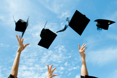 Graduation hats in air